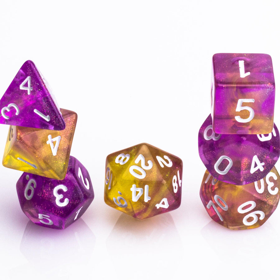 Rainbow Sherbet, purple and yellow gold translucent RPG dice with wite inking. 7 piece RPG dice set stacked on white background.