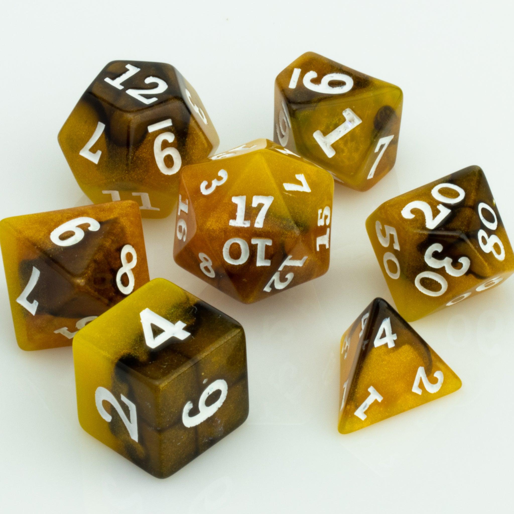 Scorch, yellow, brown and black resin DND dice 7 piece set on white background.