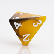 Scorch, yellow, brown and black resin DND dice 7 piece set D4 on white background.