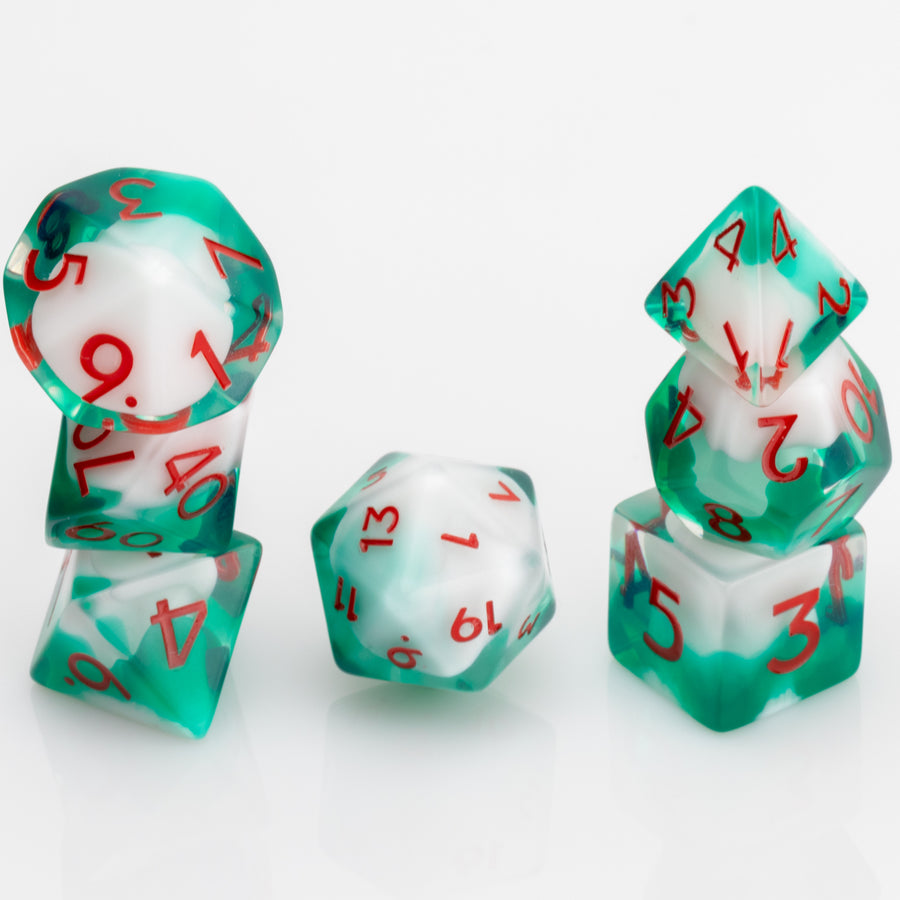 Shillelagh, white, green, and red RPG dice set stacked on a white background.