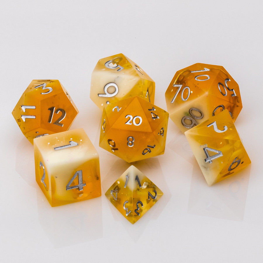 Sundown, swirling orange and white handmade RPG dice set on a white background.