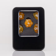 Sundown, swirling orange and white handmade RPG dice set in decorative tin on a white background.