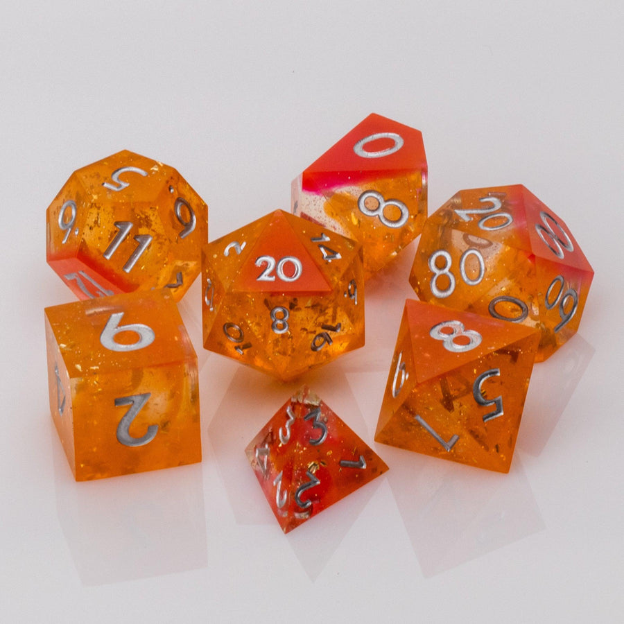 Sunfire, swirling orange and red handmade DND dice set on a white background.