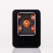 Sunfire, swirling orange and red handmade DND dice set in decorative tin on a white background.